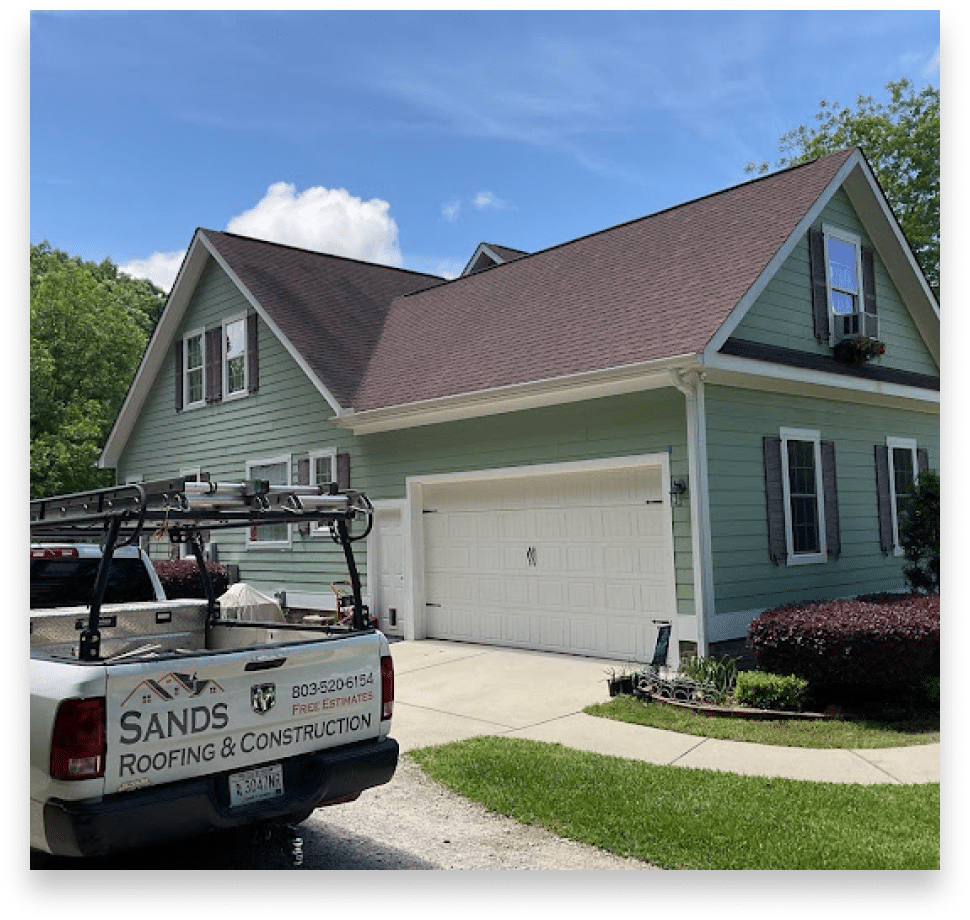 Sands Roofing & Construction branded truck at a completed roofing project in Lexington, SC